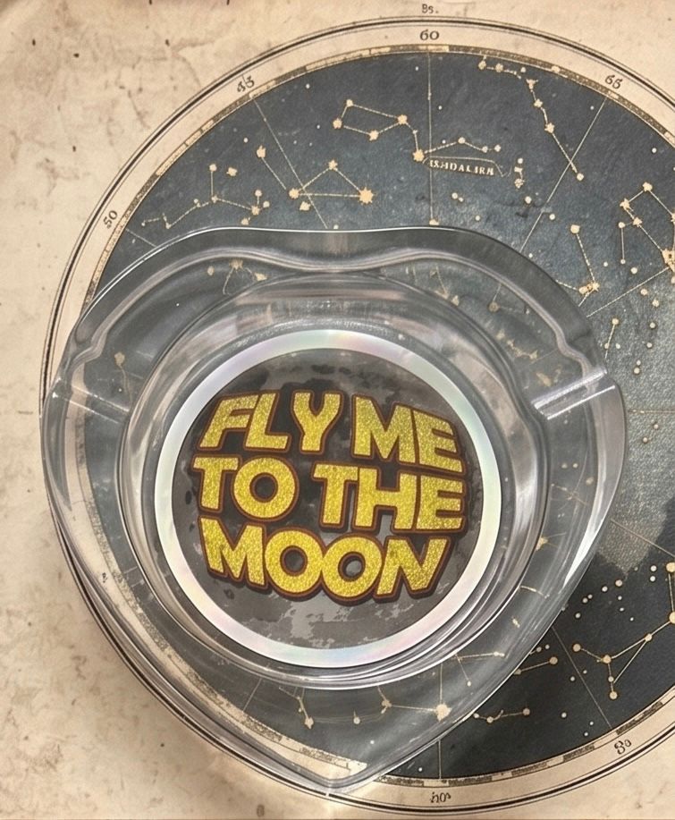 THE "FLY ME TO THE MOON" HEART-SHAPED GLASS ASHTRAY